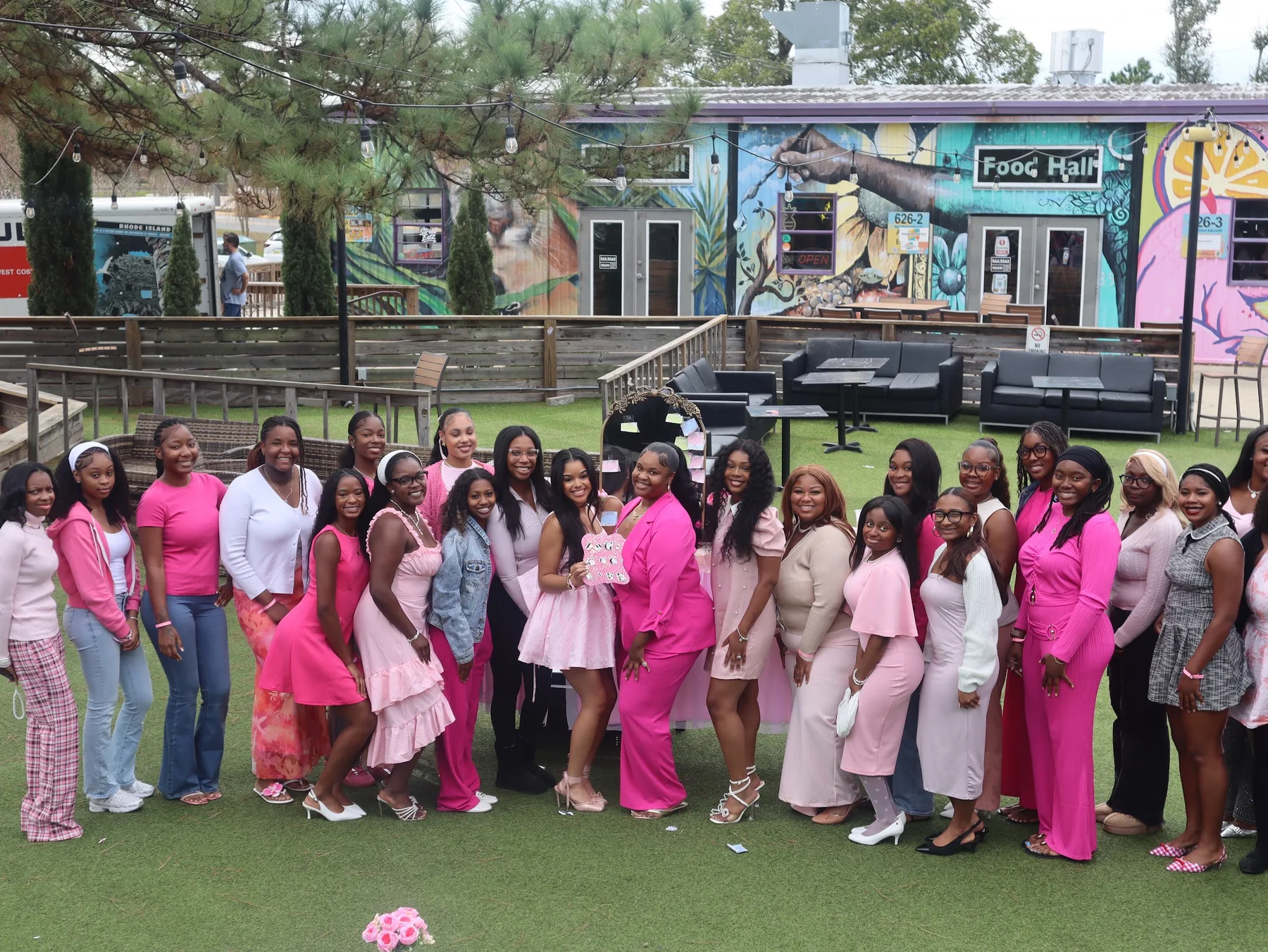 Pretty Girls Who Serve members gathered together in shades of pink